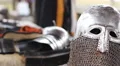 Man wearing medieval suit preparing for tilting match reenactment, male hobby HD Footage