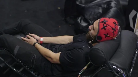 Man wearing a neural head capture device for recording brainwaves Video stock 79636203