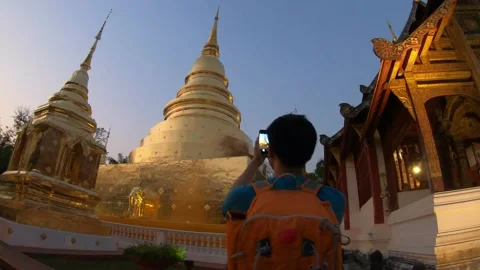 A man wearing an orange backpack is walking in temple sight seeing pagoda Stock Footage 314591910