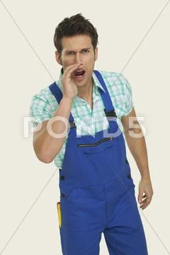 Man wearing overall shouting Stock Photos