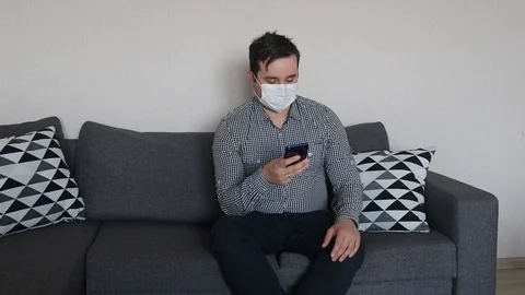 Man wearing protective mask to protect from viruses and using mobile phone Stock Footage 126711280