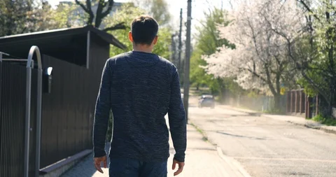 Man wearing Protective mask walking at street in spring. Back view 動画素材 129049488