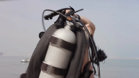 Man wearing scuba backpack at beach. Stock Footage 119508740