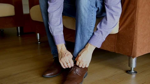 Man wearing shoe and preparing to go out Stock Footage 129175245