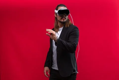Man wearing spatial computing AR headset, interacts with virtual environment Stock-Fotos
