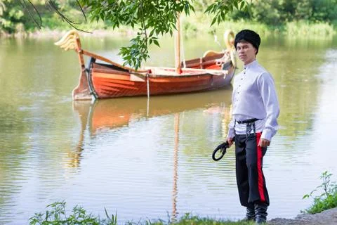Man wearing a stylized Ukrainian costumes posing with whip Stock Photos