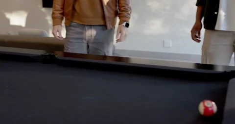 Man wearing sweater is lining, striking cue trying to sink ball on pool table, Stock-Footage 342068661