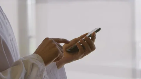 Man wearing a thawb using a smartphone Stock Footage 127123927