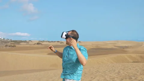 Man wearing virtual google on desert in 4K slow motion Stock Footage 88304050
