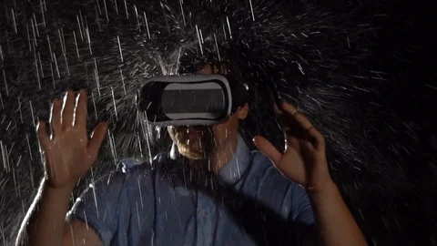 Man wearing virtual reality glasses in the rain. Technology Concept. Stock Footage 80179580