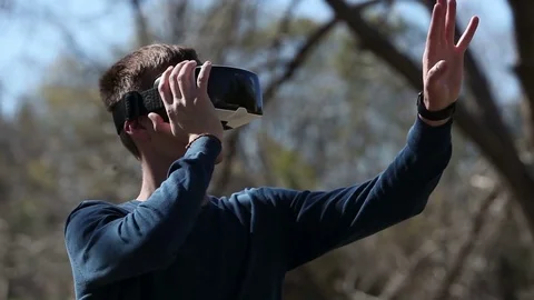 Man wearing virtual reality goggles outdoor Stock Footage 73579255
