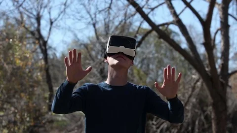 Man wearing virtual reality goggles outdoor. Future learning concept Stock Footage 73579415
