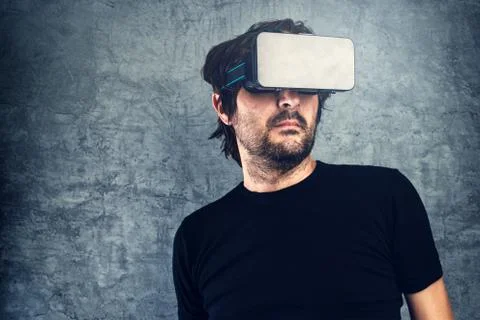 Man wearing virtual reality goggles for 3d VR multimedia content Stock Photos