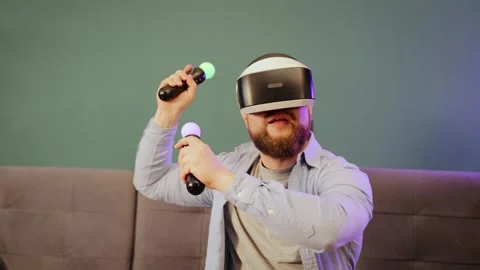 Man wearing virtual reality headset at home having fun playing video games Stock Footage 263980796