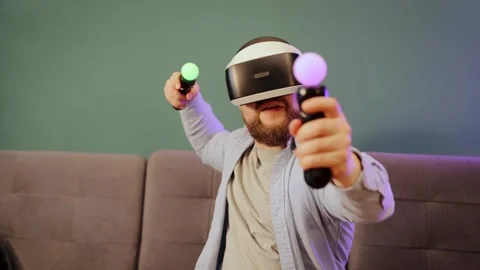 Man wearing virtual reality headset at home having fun playing video games Stock Footage 263980960