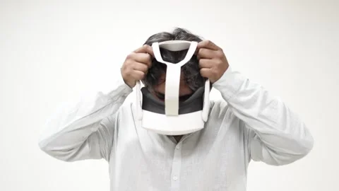 Man wearing virtual reality headset on white background 스톡 동영상 309772176