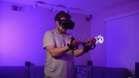 Man wearing virtual reality headset controlling virtual objects with hands Stock Footage 334086433