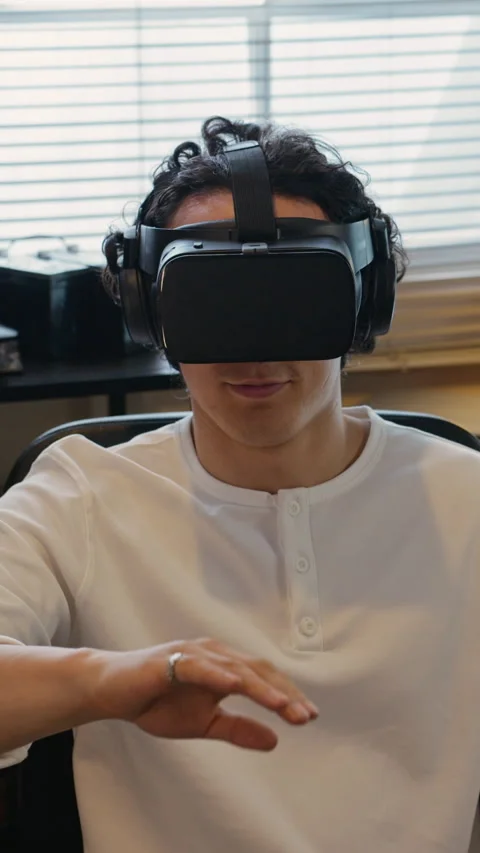 Man Wearing Virtual Reality Headset Interacting with Digital Interface Stock Footage 338421801