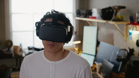 Man Wearing Virtual Reality Headset Experiencing Immersive Technology Stock Footage 338424153