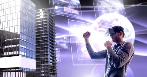 Man wearing virtual reality headset with Tall buildings with world and screens Stock Photos