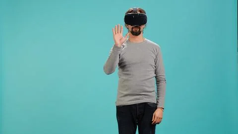 Man wearing virtual reality headset, interacting with interface, Stock Photos