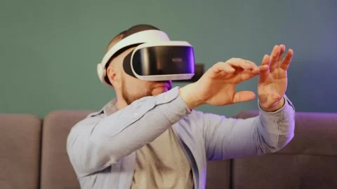 Man wearing VR glasses making some gestures like scaling and swiping photos Stock Footage 263980981