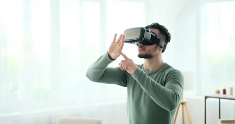 Man wearing vr headset and operating virtual screen 스톡 동영상 156521645