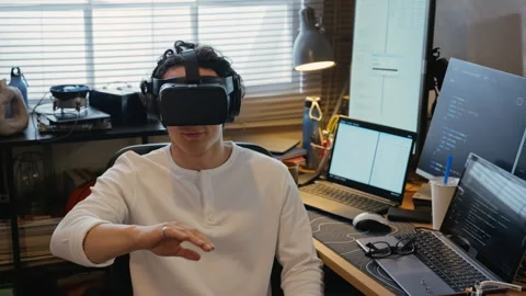 Man Wearing Vr Headset Interacting with Virtual Interface in Workspace Stock Footage 338424280