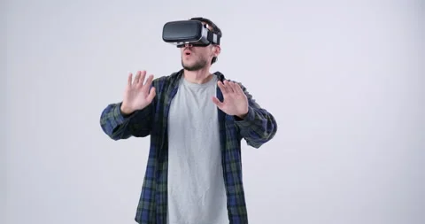 Man wearing VR headset pressing button on virtual screen Stock Footage 143945254