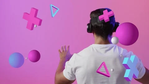 Man wearing VR headset raising hands upon floating 3D shapes appearing reaching Stock Footage 335465466