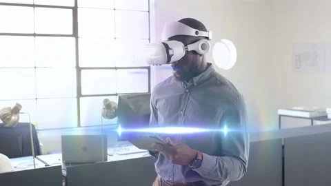 Man wearing VR holding tablet, tapping and pinching, activating tech UI for Stock Footage 333975675