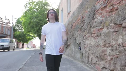 Man wearing white blank t-shirt and black jeans with space for your logo Stock Footage 130333553