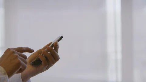 Man wearing a white thawb using a smartphone Stock Footage 127129585