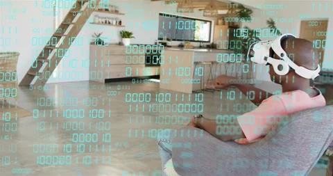 Man wearing white VR headset raising hand selecting items via turquoise binary Stock Footage 320955681