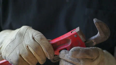 Man wearing workgloves with wrench Stock Footage 42770484