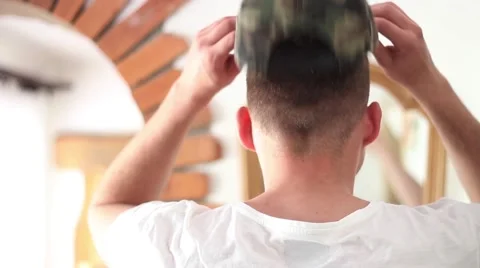 Man wears a camo snapback Stock Footage 62803101
