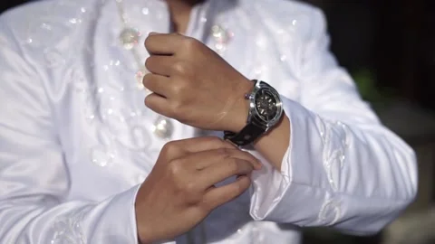 A man wears a cool watch before his wedding Stock Footage 239031733