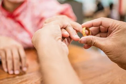 A man wears an engagement ring to propose at a shopping mall which expresse.. Stock Photos