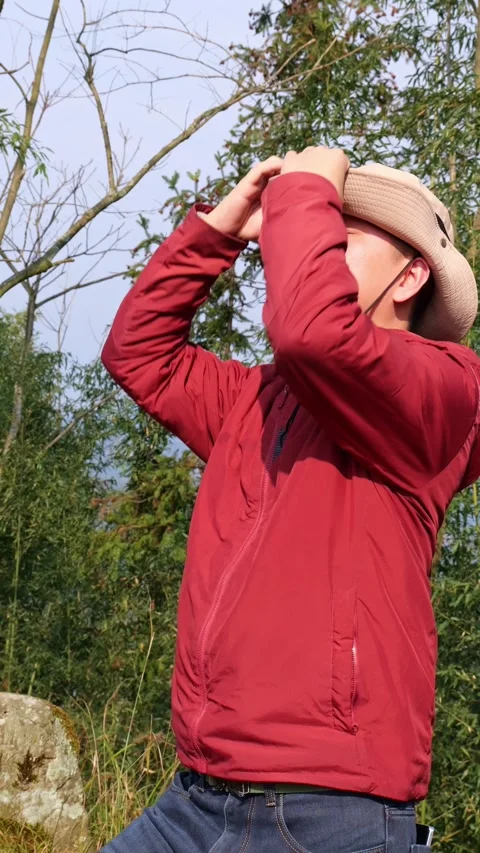 A man wears a hat so the sun doesn’t burn his face. Stock Footage 329550107