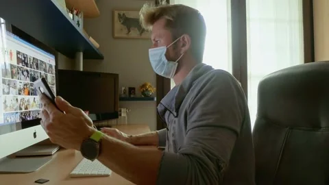 Man Wears a Medical Mask to Using Smartphone and Computer Stock-Footage 141384153