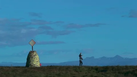 A man wears a son on his shoulders and walks along the plain. Andreev. Stock Footage 78007875