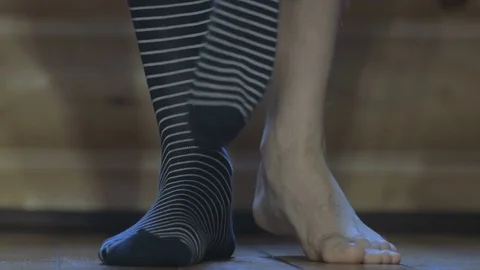 The man wears striped socks Stock Footage 70687975