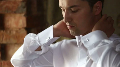 Man wears a tie at the window in the castle close up Stock Footage 39505043