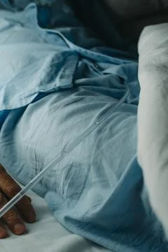 Man wears a urinary catheterization lying in bed Stock Photos