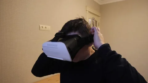A man wears virtual reality glasses. Video stock 143838244