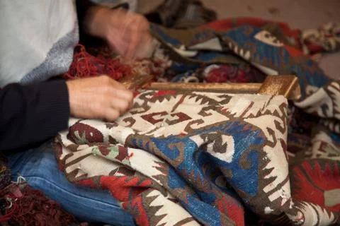 Man  weaving a carpet Stock Photos