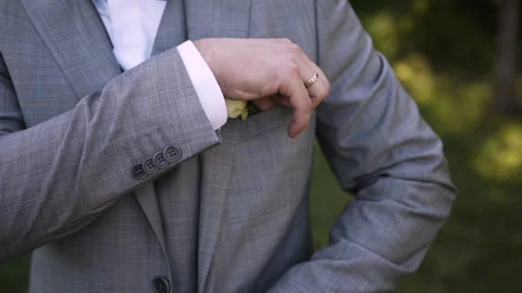 Man with wedding ring in suit and vest and bow tie straightens pockets in jacket Stock Footage 147018253