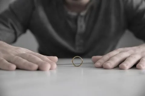 Man with wedding ring at table, closeup. Cheating and breakup Stock Photos