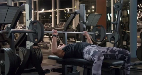 Man weight training gym exercise 4k video. Male bench pressing barbell for chest Stock Footage 71797134