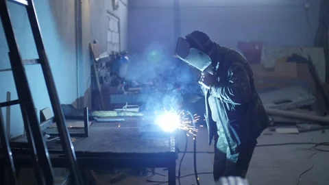 A man  weld a metal construction Stock Footage 130710724